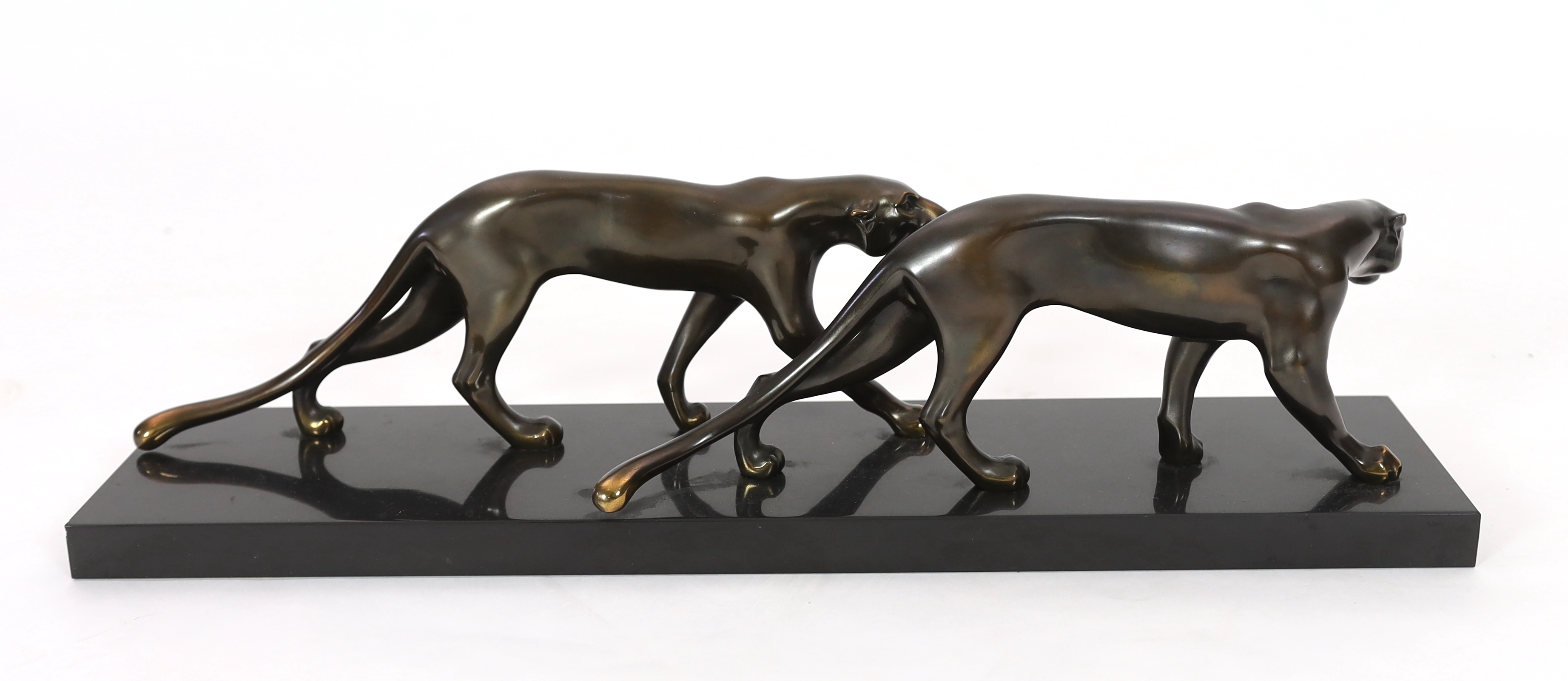 Marty Font, a French Art Deco bronzed and black marble group of two prowling panthers, 68cm wide, 18cm high